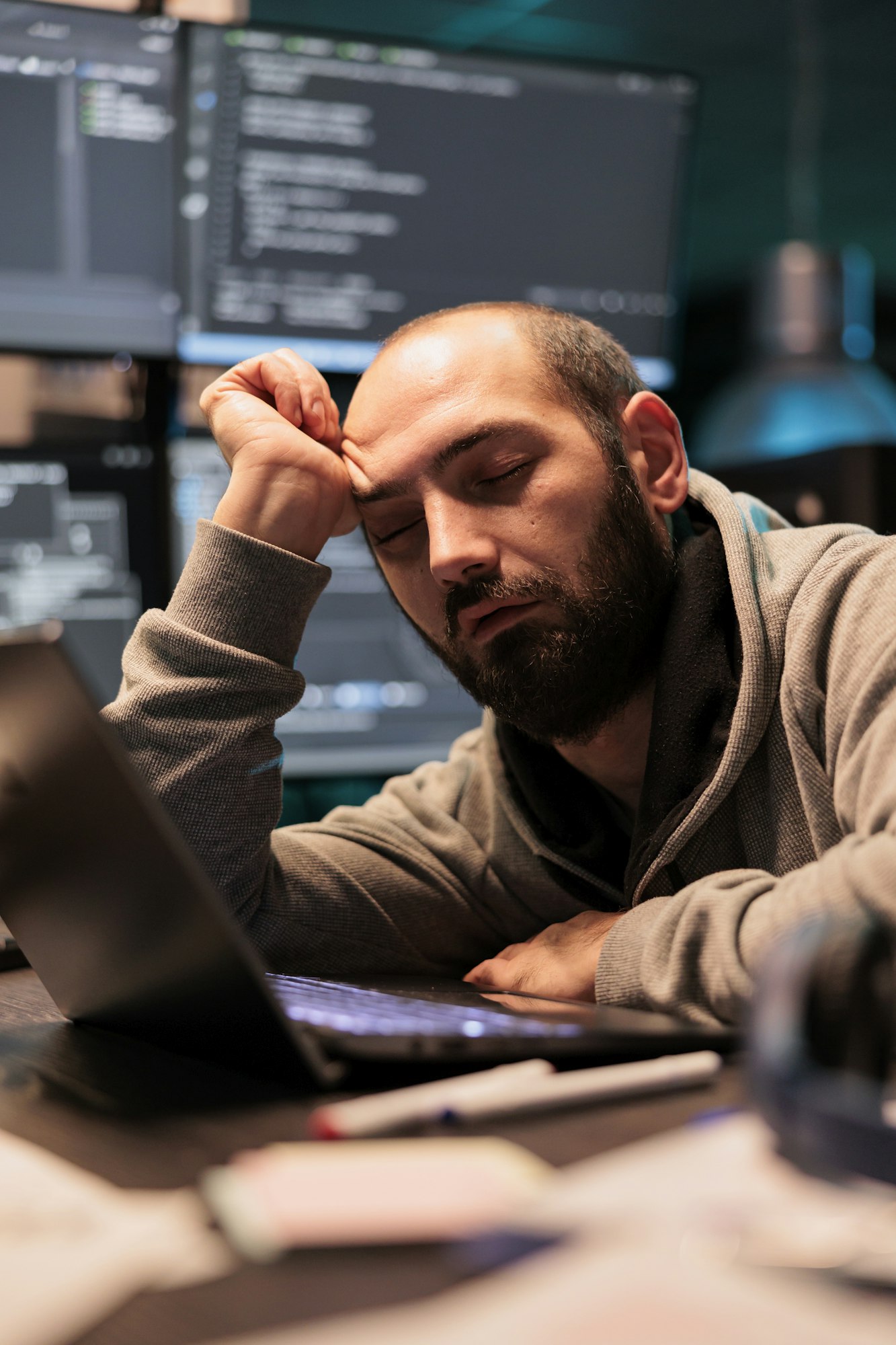 Tired IT enigneer falling asleep at office desk Tired IT enigneer falling asleep at office desk