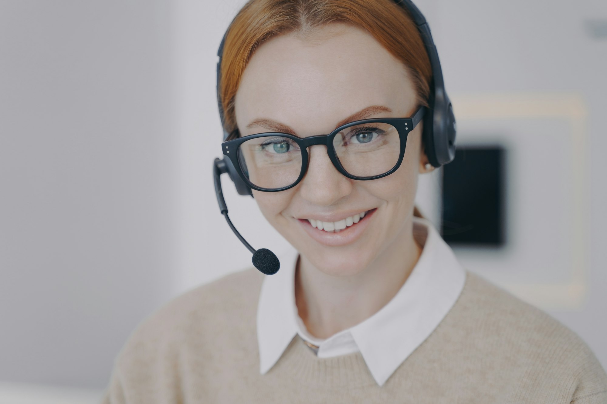 Online consultant of call center. Young woman in earphones provides information by telephone. Online consultant of call center. Young woman in earphones provides information by telephone.
